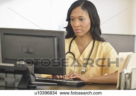 Female nurse at station View Large Photo Image Picture - Female nurse at station. Fotosearch