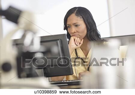 Stock Photo - Female nurse at station. Fotosearch