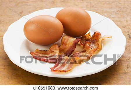 Stock Image - Fried bacon and eggs. Fotosearch