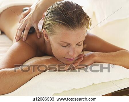 getting hot stone therapy in spa View Large Photo Image Stock Image - getting hot stone therapy in spa. Fotosearch