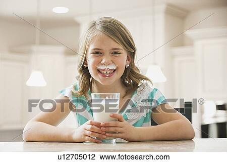 Girl (6-7) drinking milk View Large Photo Image Stock Image - Girl (6-7) drinking milk. Fotosearch