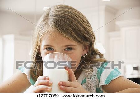 Stock Photo - Girl (6-7) drinking milk. Fotosearch