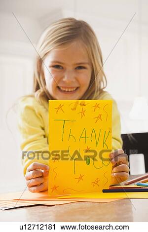 Girl (6-7) holding drawing with text 'thank you' View Large Photo Image Stock Image - Girl (6-7) holding drawing with text 'thank you'. Fotosearch