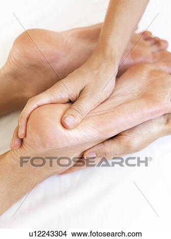 Picture - Hand massaging feet. Fotosearch