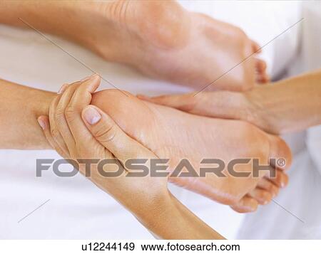 Stock Photo - Hand massaging feet. Fotosearch