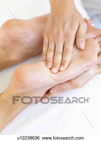 Stock Photograph - Hand massaging feet. Fotosearch