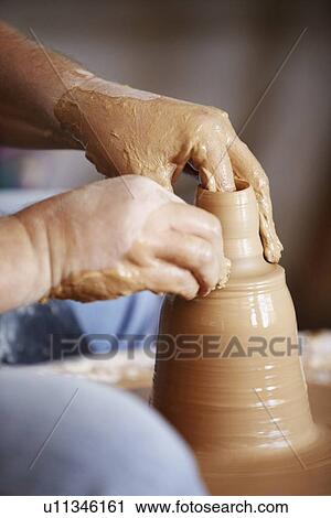 Hands working with clay on potter's wheel View Large Photo Image Stock Image - Hands working with clay on potter's wheel. Fotosearch