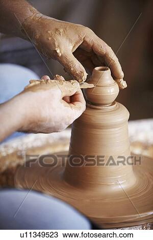 Hands working with clay on potter's wheel View Large Photo Image Stock Image - Hands working with clay on potter's wheel. Fotosearch