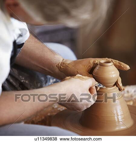 Hands working with clay on potter's wheel View Large Photo Image Stock Photo - Hands working with clay on potter's wheel. Fotosearch
