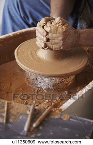 Hands working with clay on potter's wheel View Large Photo Image Stock Photo - Hands working with clay on potter's wheel. Fotosearch