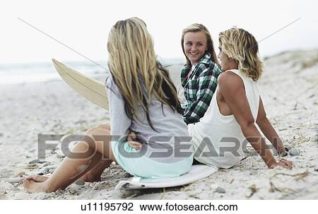 Man and women relaxing on beach View Large Photo Image Stock Image - Man and women relaxing on beach. Fotosearch