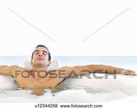 Man relaxing in bathtub View Large Photo Image Stock Photo - Man relaxing in bathtub. Fotosearch