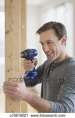 Man using hand drill View Large Photo Image Stock Image - Man using hand drill. Fotosearch