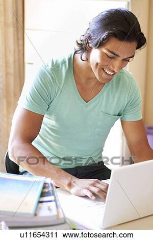 Stock Image - Man using laptop. Fotosearch