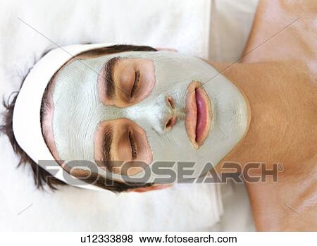 Stock Photo - Man with face mask relaxing in spa. Fotosearch