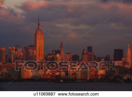 Manhattan skyline at sunset View Large Photo Image Stock Photo - Manhattan skyline at sunset. Fotosearch