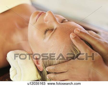 Mid adult woman receiving head massage View Large Photo Image Stock Image - Mid adult woman receiving head massage. Fotosearch