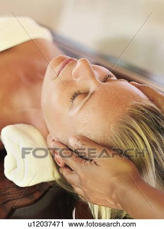 Mid adult woman receiving head massage View Large Photo Image Stock Image - Mid adult woman receiving head massage. Fotosearch