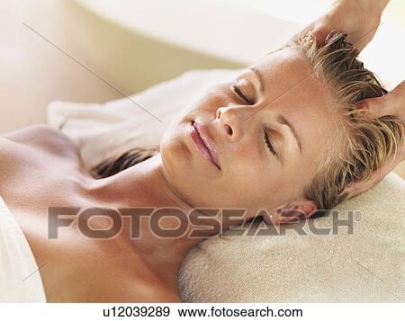 Mid adult woman receiving head massage View Large Photo Image Stock Photo - Mid adult woman receiving head massage. Fotosearch