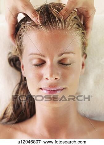 Mid adult woman receiving head massage View Large Photo Image Stock Photo - Mid adult woman receiving head massage. Fotosearch