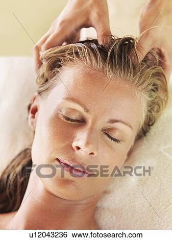 Stock Photograph - Mid adult woman receiving head massage. Fotosearch