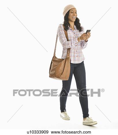 Mid adult woman using phone View Large Photo Image Stock Photo - Mid adult woman using phone. Fotosearch