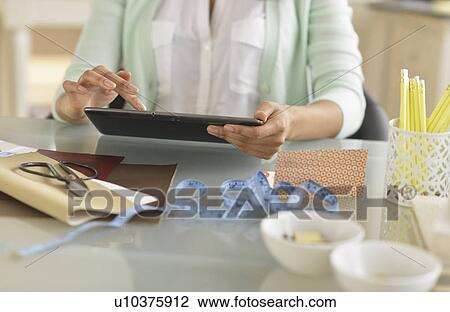 Midsection of woman using digital tablet View Large Photo Image Stock Image - Midsection of woman using digital tablet. Fotosearch