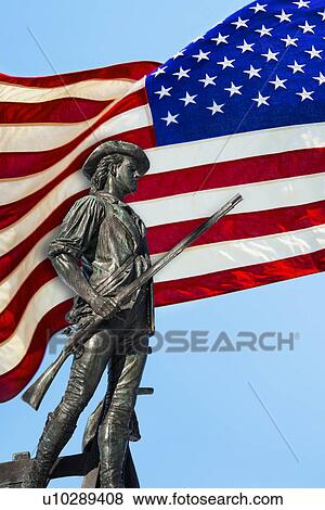 Stock Photo - Minutemam statue with flag. Fotosearch