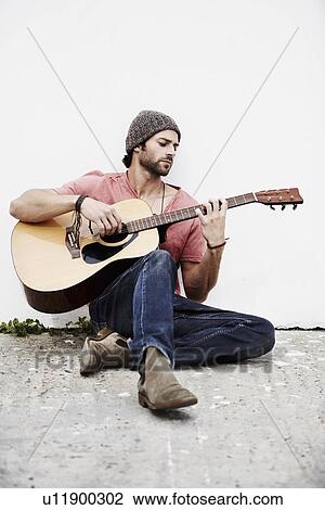 Musician playing guitar outdoors View Large Photo Image Stock Image - Musician playing guitar outdoors. Fotosearch