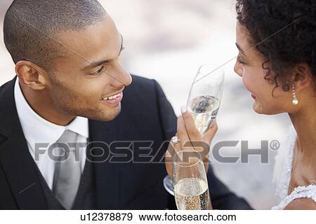 Newly wed couple drinking champagne View Large Photo Image Stock Photo - Newly wed couple drinking champagne. Fotosearch