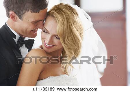 Newly wed couple embracing View Large Photo Image Stock Photo - Newly wed couple embracing. Fotosearch