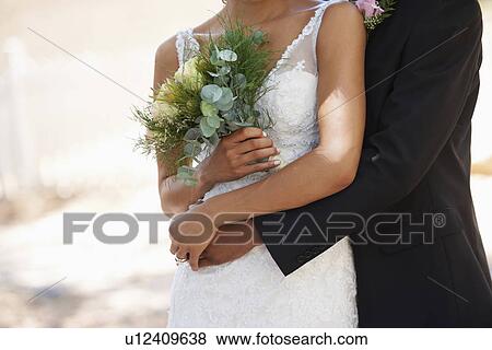 Newlywed couple embracing View Large Photo Image Stock Photo - Newlywed couple embracing. Fotosearch