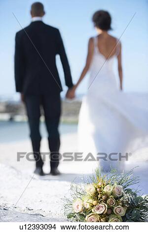 Picture - Newlywed couple on beach. Fotosearch