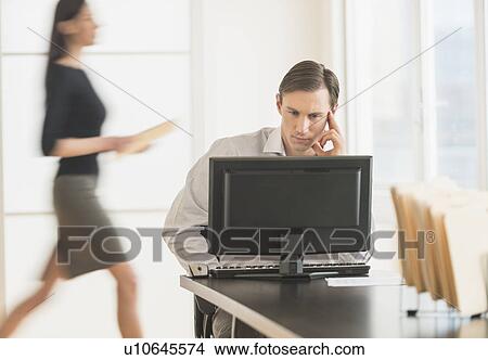 Office worker using computer View Large Photo Image Picture - Office worker using computer. Fotosearch