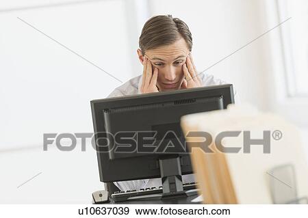 Office worker using computer View Large Photo Image Stock Photo - Office worker using computer. Fotosearch