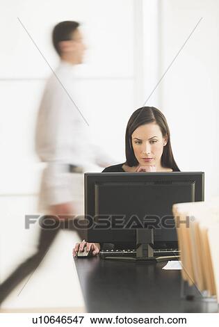 Office worker using computer View Large Photo Image Stock Photo - Office worker using computer. Fotosearch