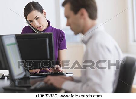 Office workers using computers View Large Photo Image Stock Image - Office workers using computers. Fotosearch