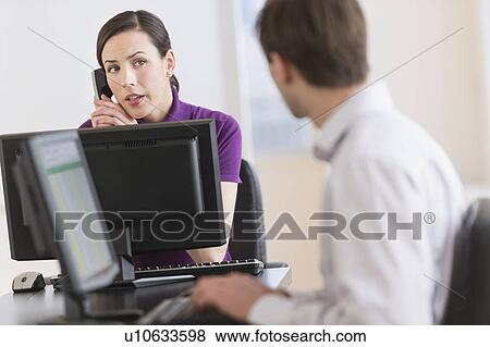 Office workers using computers View Large Photo Image Stock Photo - Office workers using computers. Fotosearch