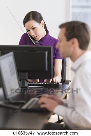 Office workers using computers View Large Photo Image Stock Photo - Office workers using computers. Fotosearch