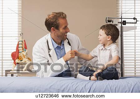 Stock Photograph - Pediatrician and boy (2-3). Fotosearch