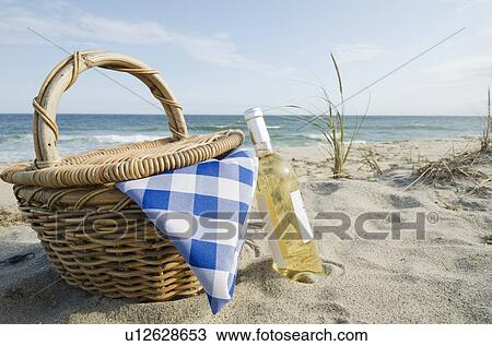 Picnic basket and white wine on beach View Large Photo Image Stock Image - Picnic basket and white wine on beach. Fotosearch