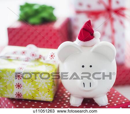 Stock Image - Piggy bank and christmas gifts. Fotosearch