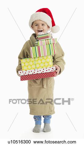 Portrait of boy (4-5) carrying christmas presents View Large Photo Image Stock Image - Portrait of boy (4-5) carrying christmas presents. Fotosearch