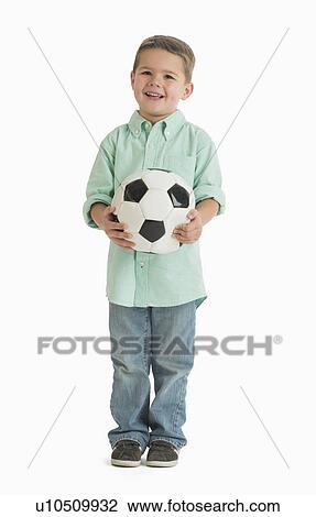 Stock Image - Portrait of boy (4-5) holding soccer ball. Fotosearch