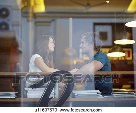 Portrait of couple talking in coffee shop View Large Photo Image Stock Photo - Portrait of couple talking in coffee shop. Fotosearch