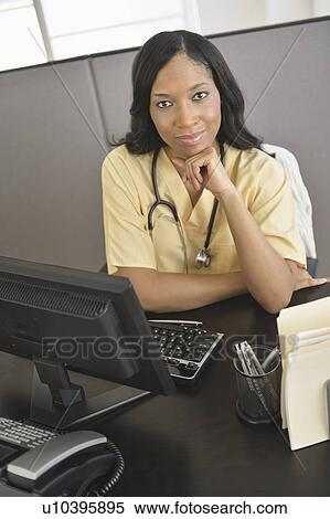 Portrait of female nurse at station View Large Photo Image Stock Photography - Portrait of female nurse at station. Fotosearch