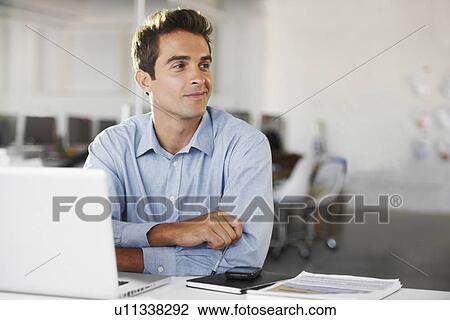 Stock Image - Portrait of man at office. Fotosearch