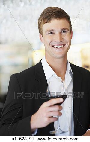 Stock Image - Portrait of man drinking wine. Fotosearch