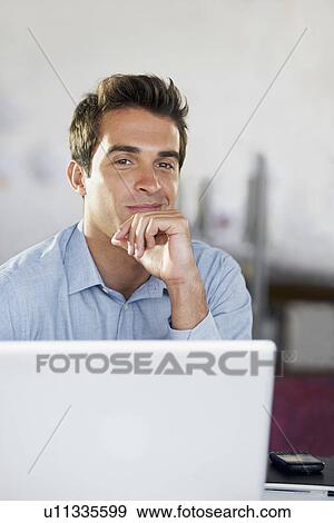 Stock Photo - Portrait of man with laptop. Fotosearch