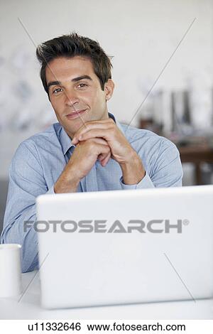 Stock Photograph - Portrait of man with laptop. Fotosearch